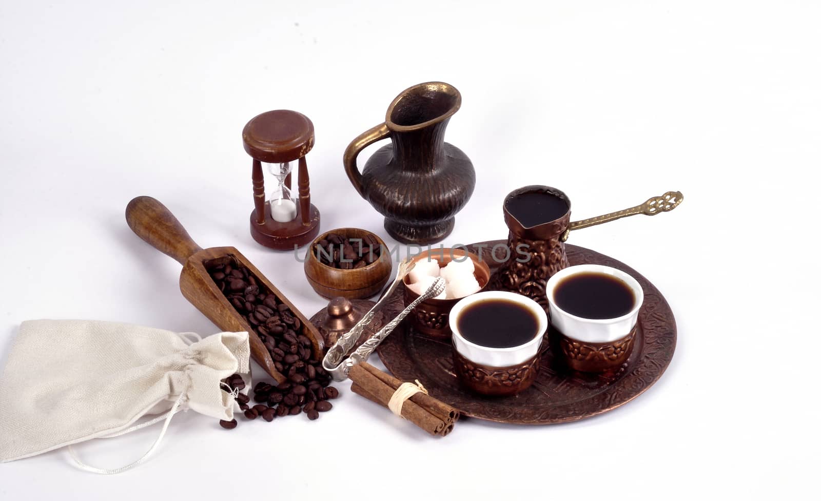 Coffee in copper coasters with accessories  for coffee-drinking on a white background