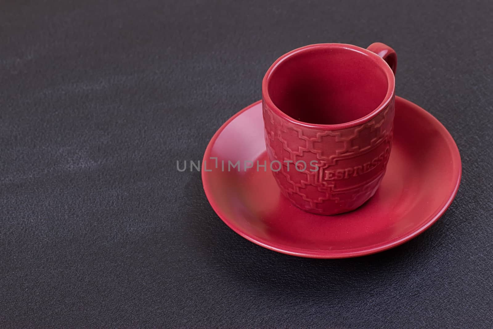 Red coffee cup on the black background