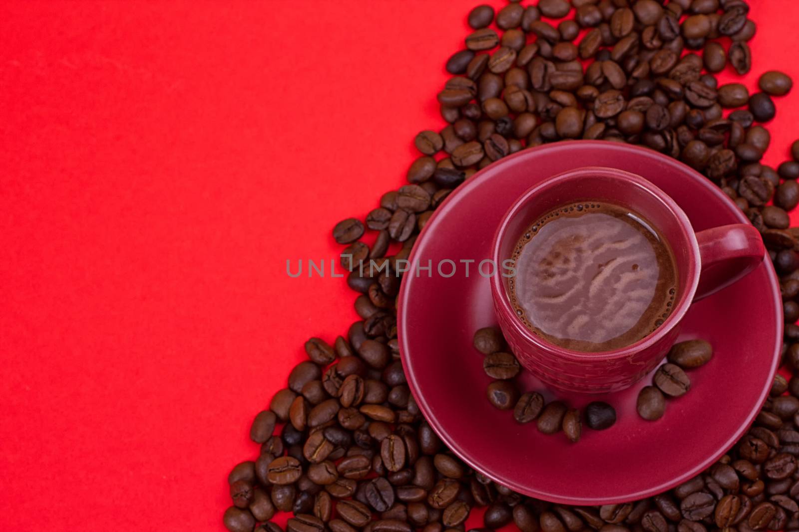 coffee cup with coffee beans on a red background