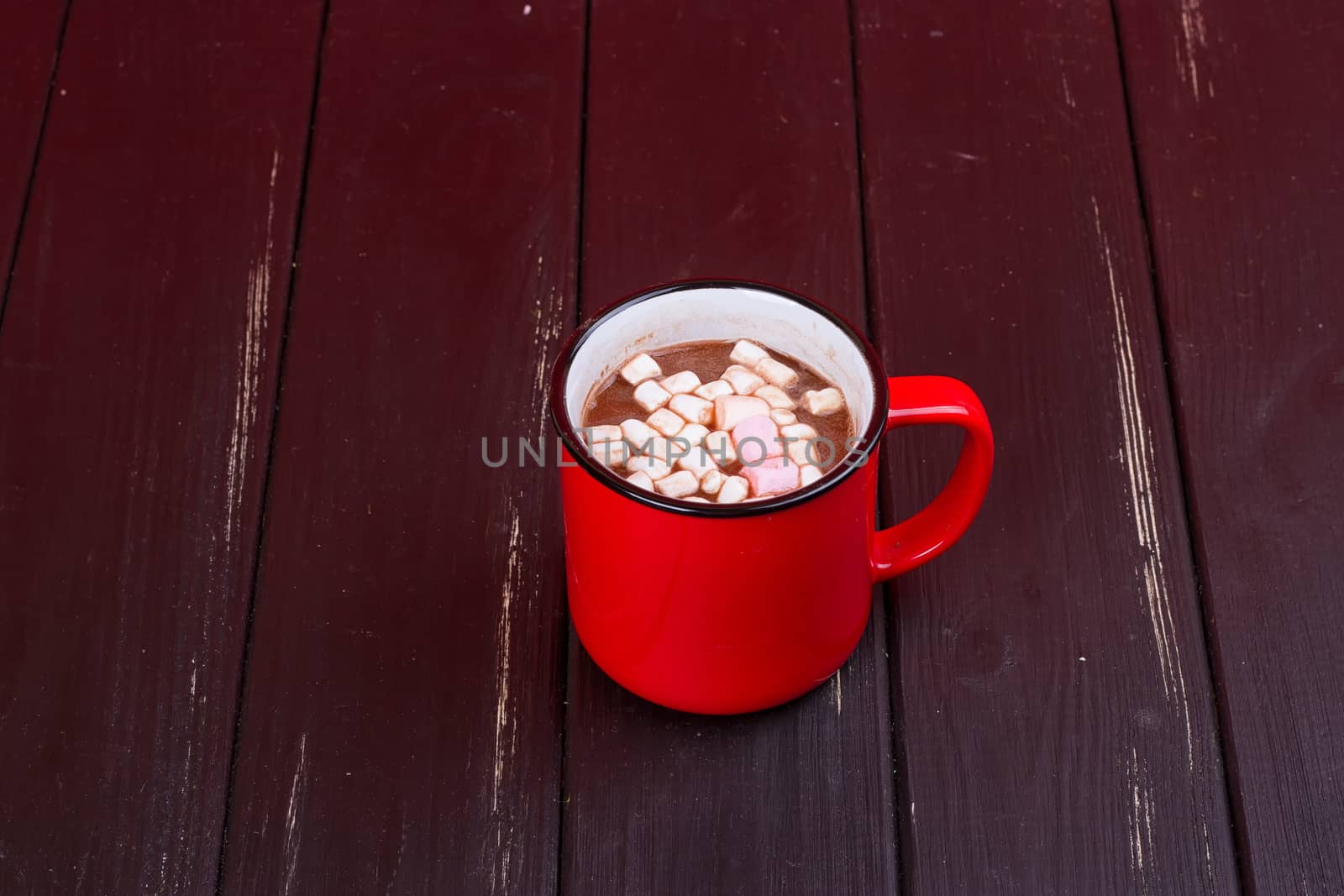Hot chocolate with marshmallows on the black background