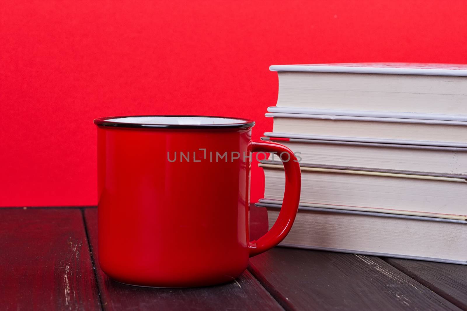 Old vintage books and a red mug
