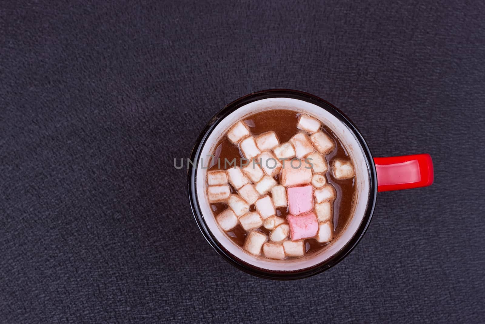 Hot chocolate with marshmallows on the black background
