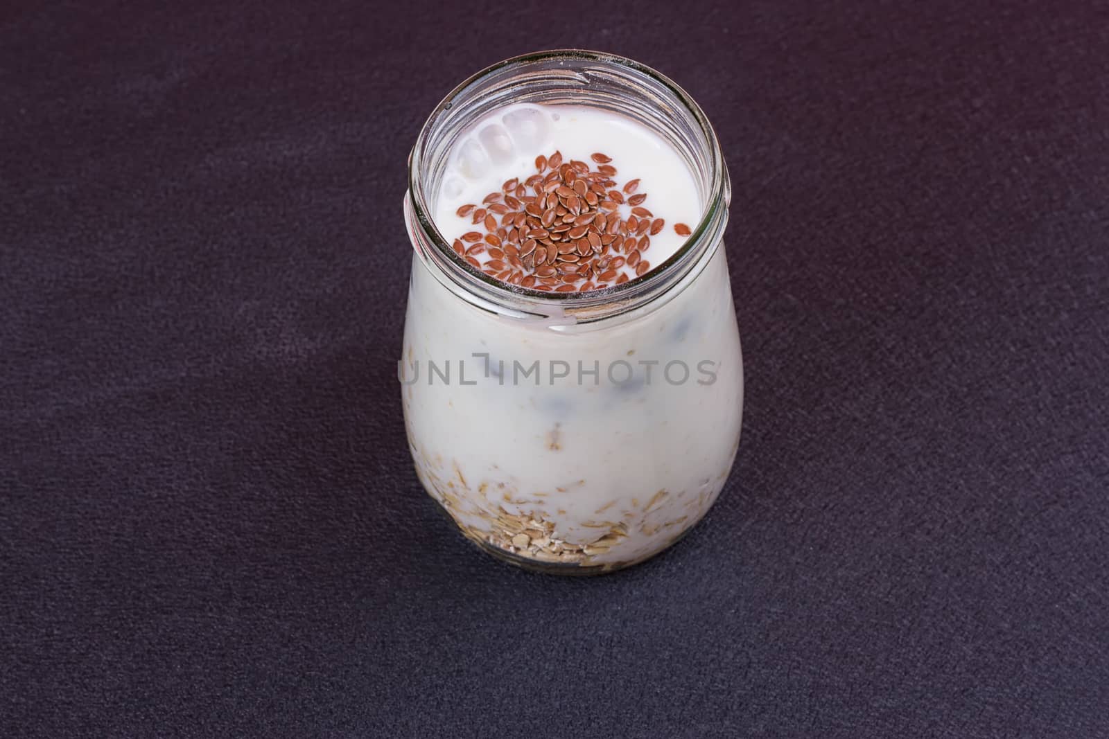 Healthy breakfast - yogurt with blueberries and muesli served in glass jar by victosha