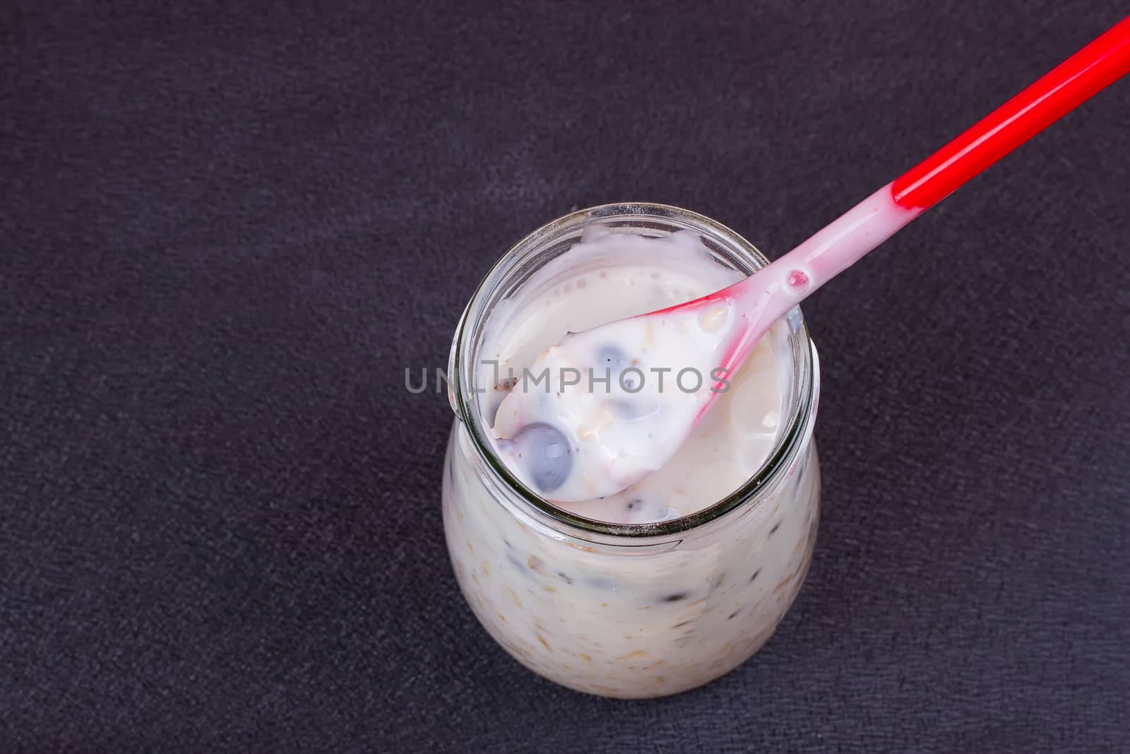 Healthy breakfast - yogurt with blueberries and muesli served in glass jar, Lazy oatmeal