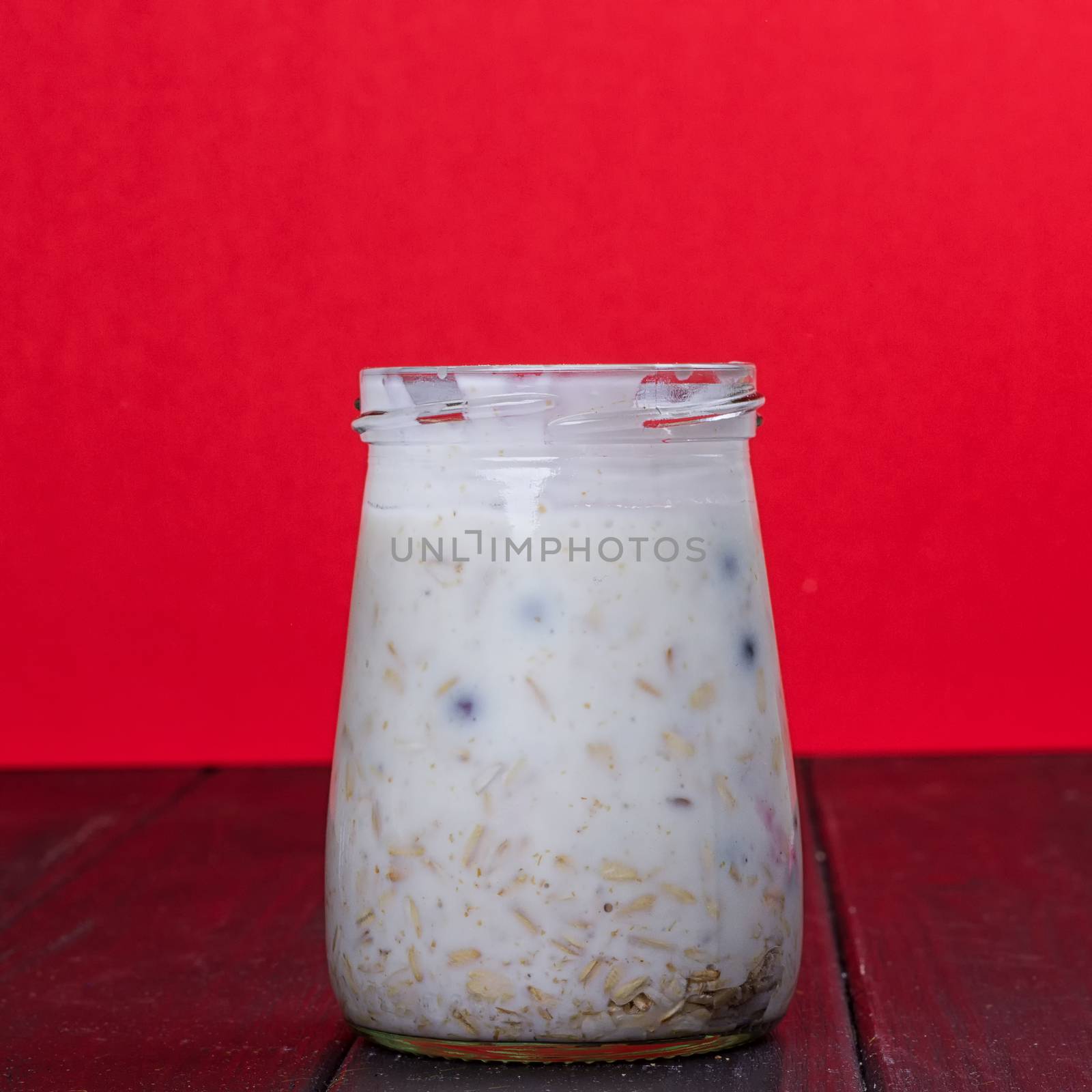 Healthy breakfast - yogurt with blueberries and muesli served in glass jar, Lazy oatmeal