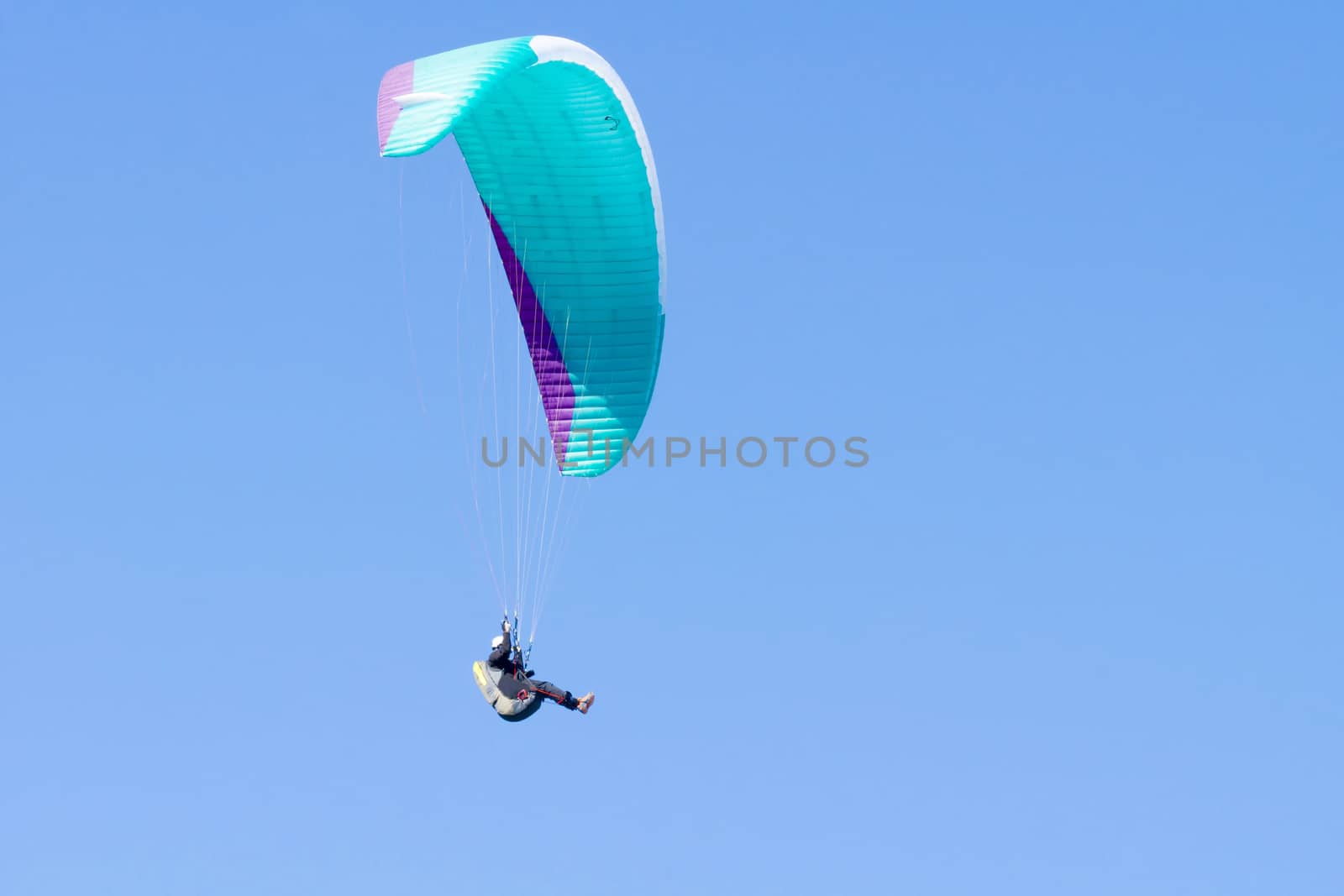 Paragliding in Denmark over the against clear blue sky by Fr@nk