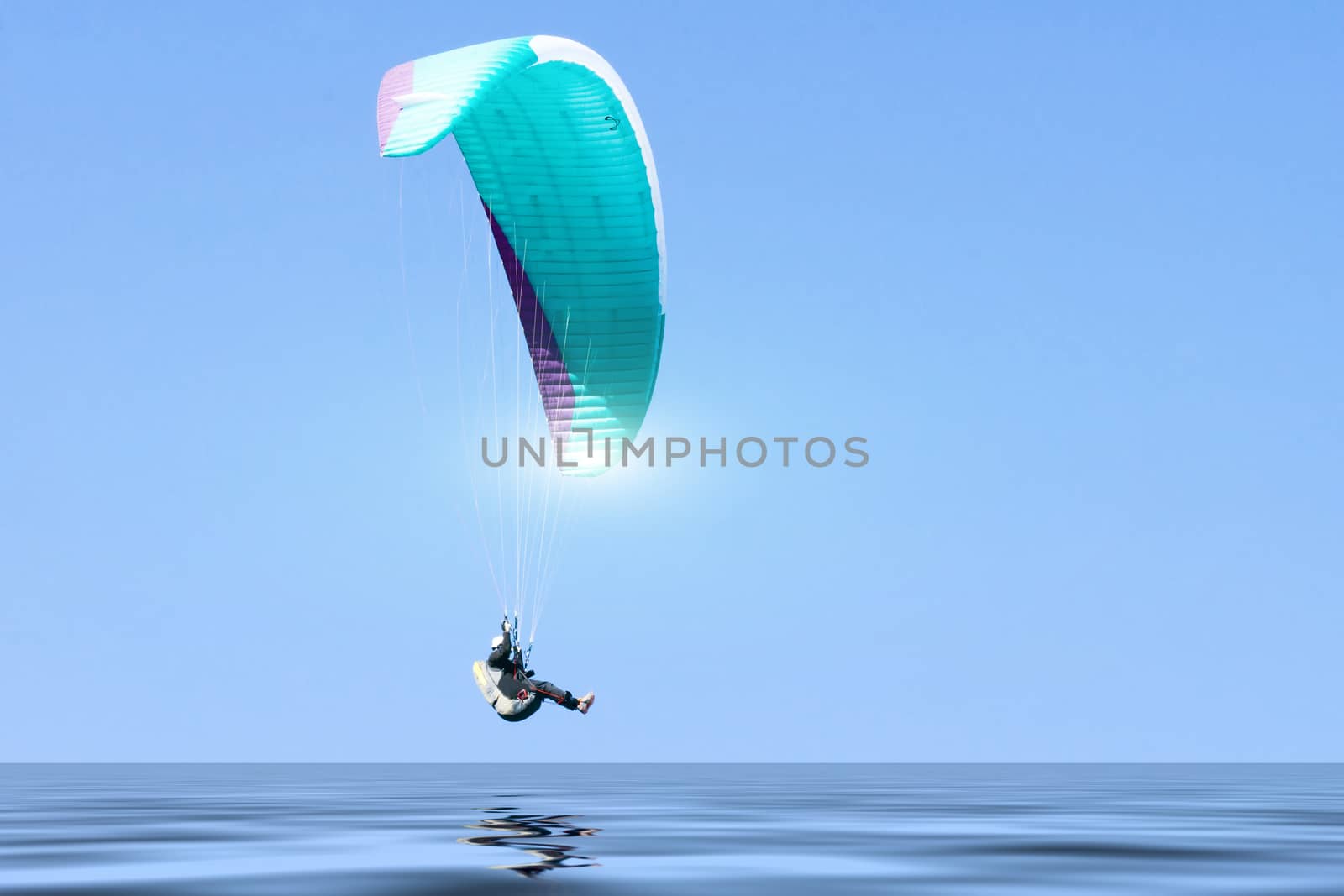 Paragliding in Denmark over the against clear blue sky by Fr@nk