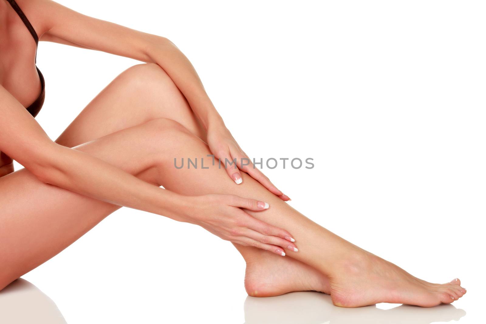 Woman's legs with clean and smooth skin on white background, isolated