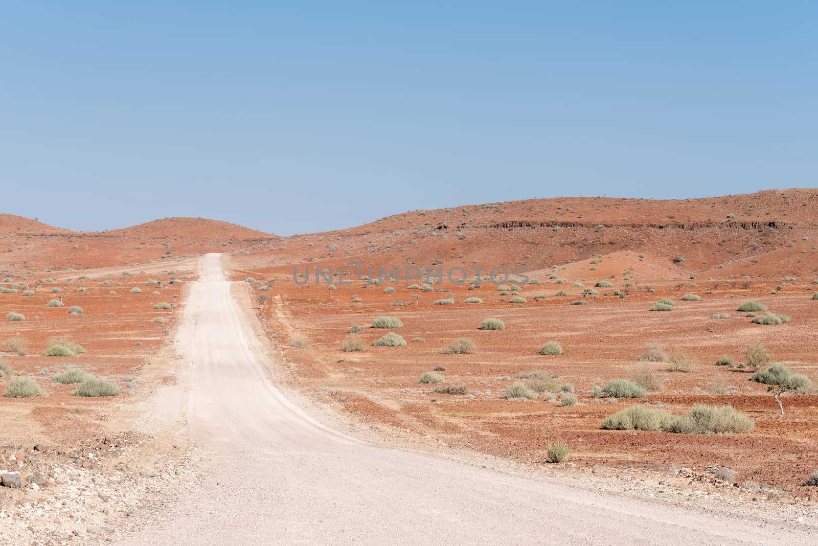 The orange-red, rocky Namib desert landscape at Dopsteekhoogte Pass on the C39-road to Torra Bay, in the Kunene Region of Namibia
