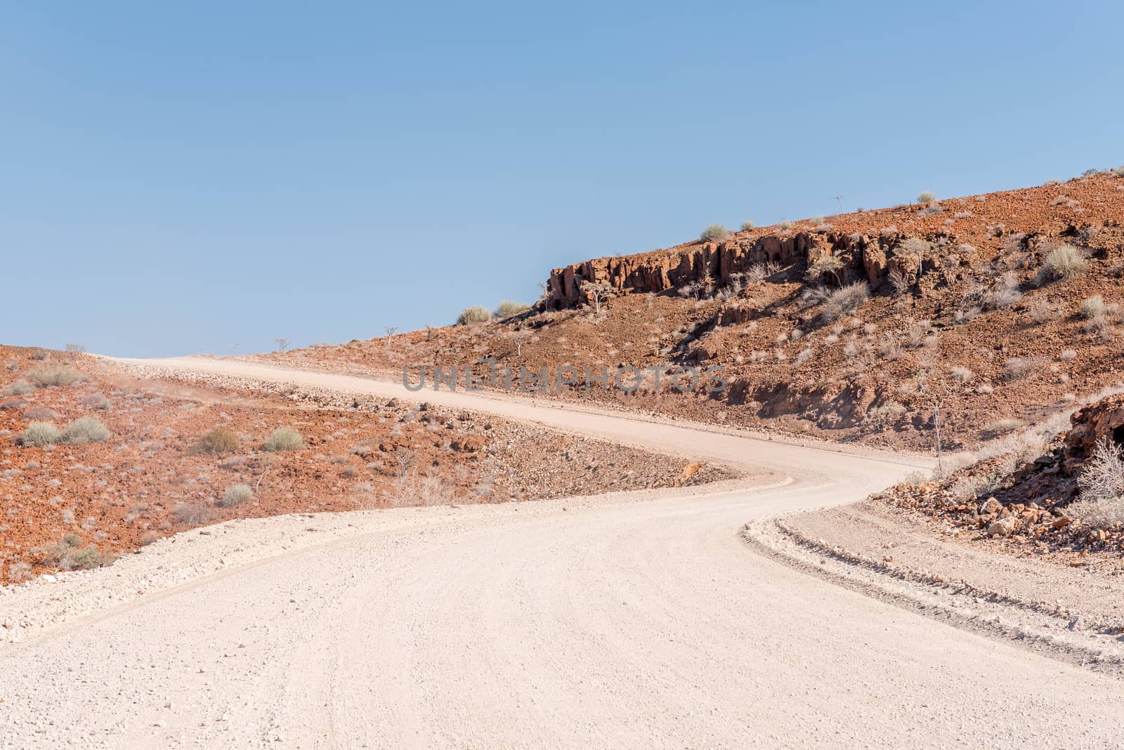 The orange-red, rocky Namib desert landscape at Dopsteekhoogte Pass on the C39-road to Torra Bay, in the Kunene Region of Namibia