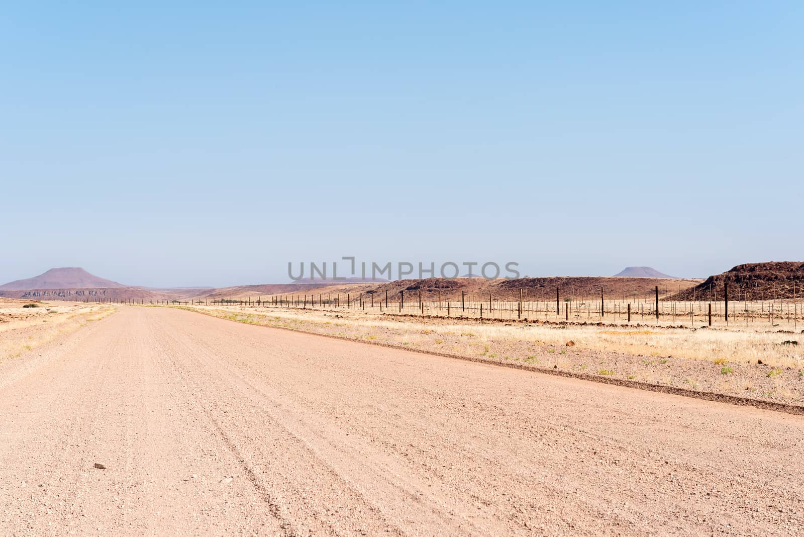 The C39-road between Dopsteekhoogte Pass and Torra Bay, in the Kunene Region of Namibia. The Red line, a veterinary fence, is to the right