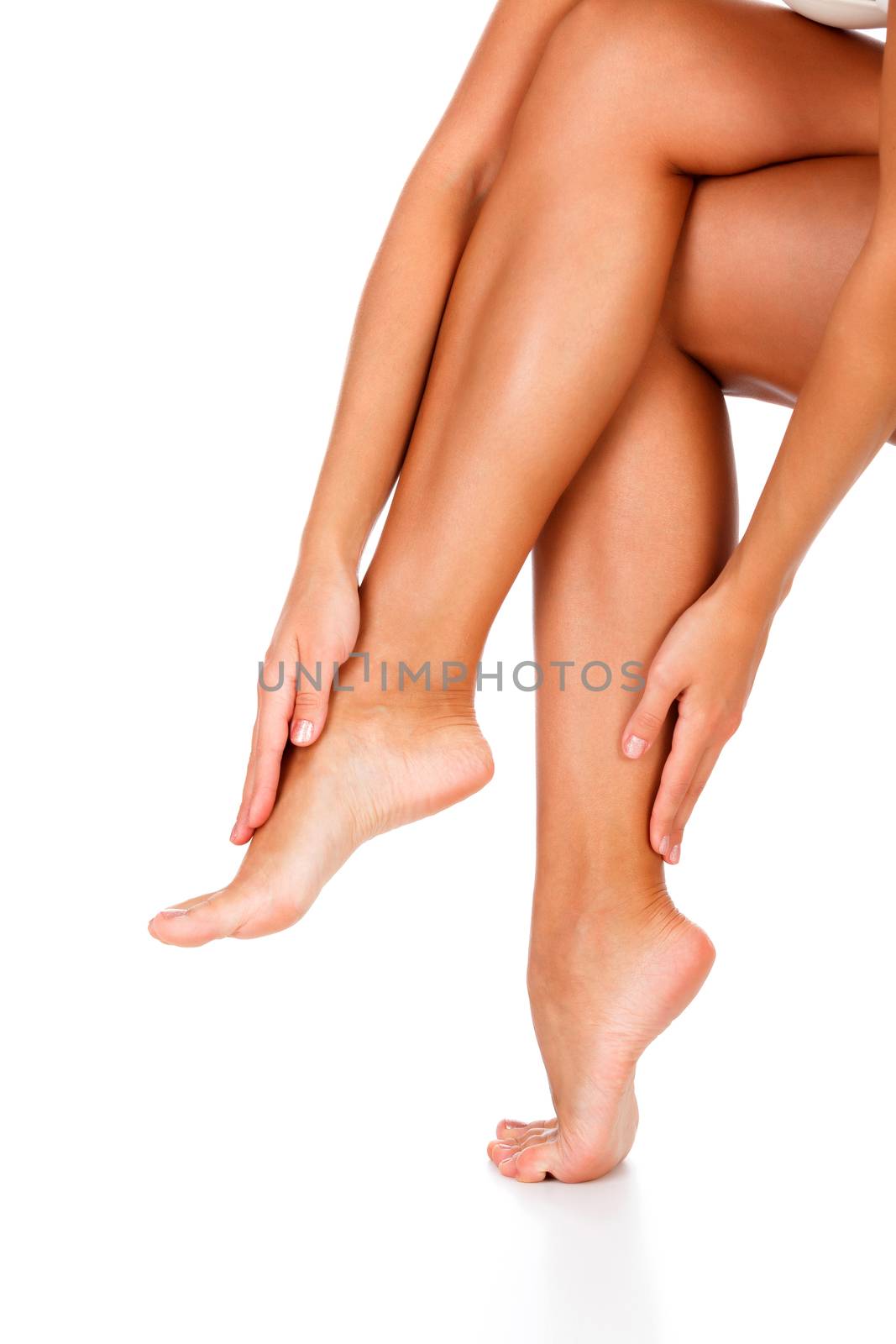 Woman's legs with clean and smooth skin on white background, isolated