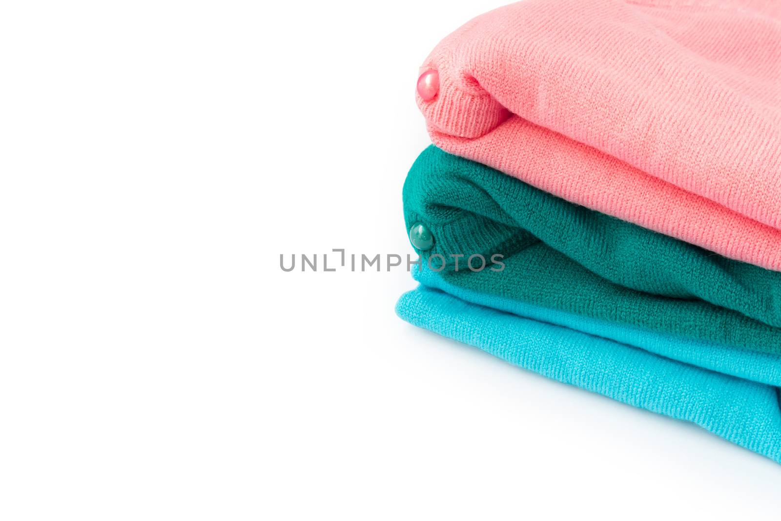 Closeup stack of clothes knitting sweater on white background