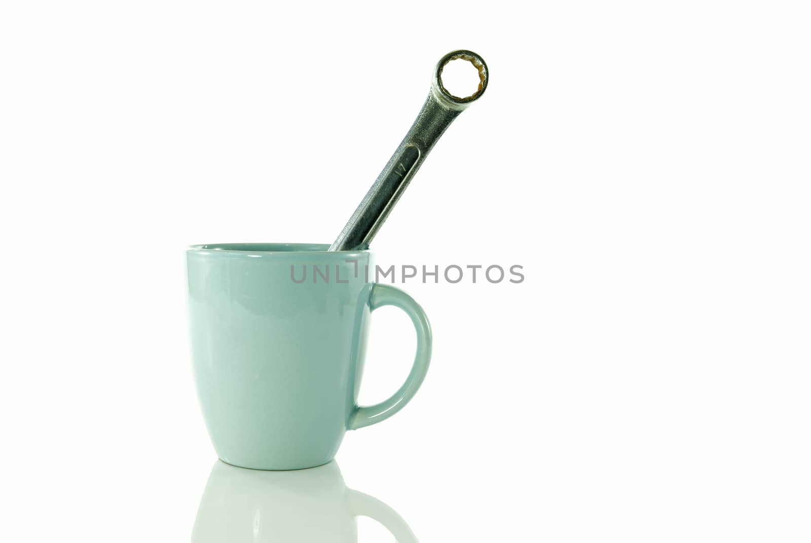time for a coffee break during work with blue coffe cup and metal boxwrench or spanner isolated on white