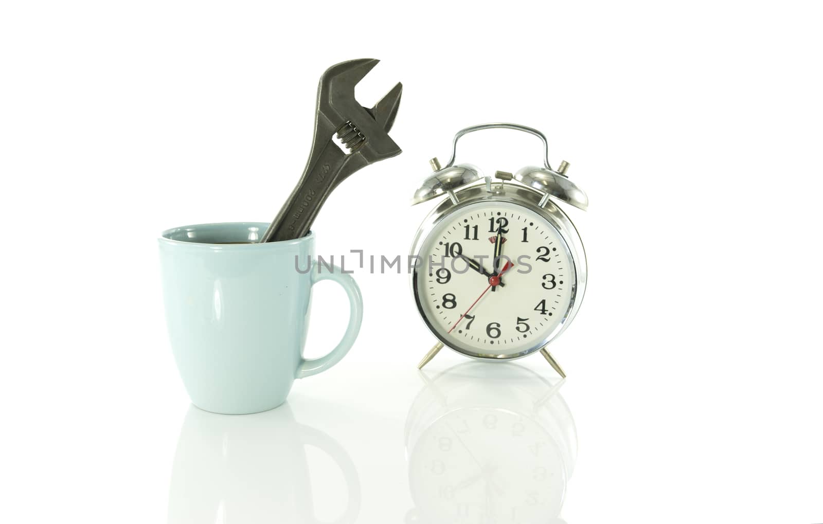 time for a coffee break during work with blue coffee cup and metal tool and clock on ten o clock