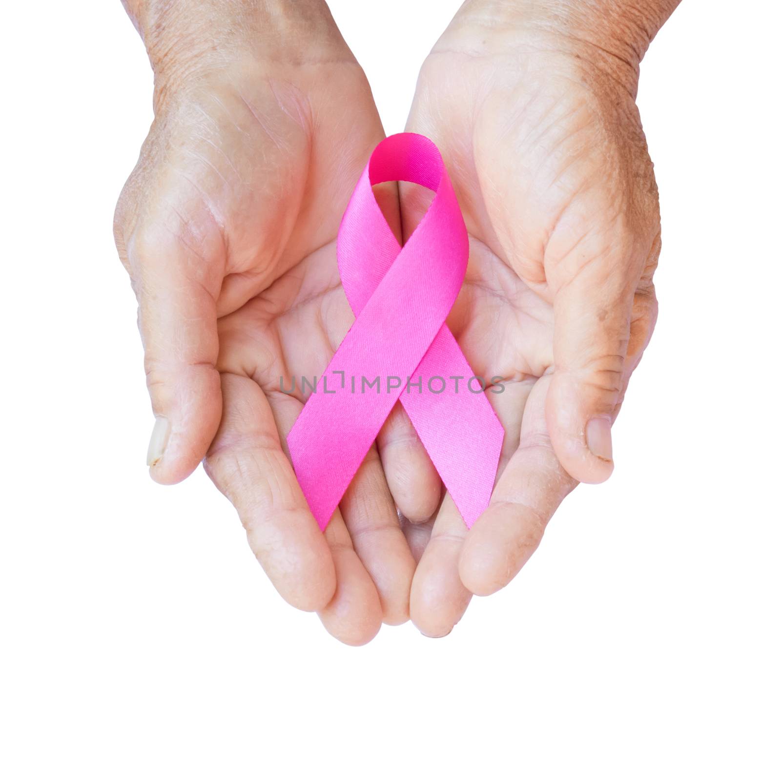 Closeup Old woman hand holding pink ribbon on white background by pt.pongsak@gmail.com