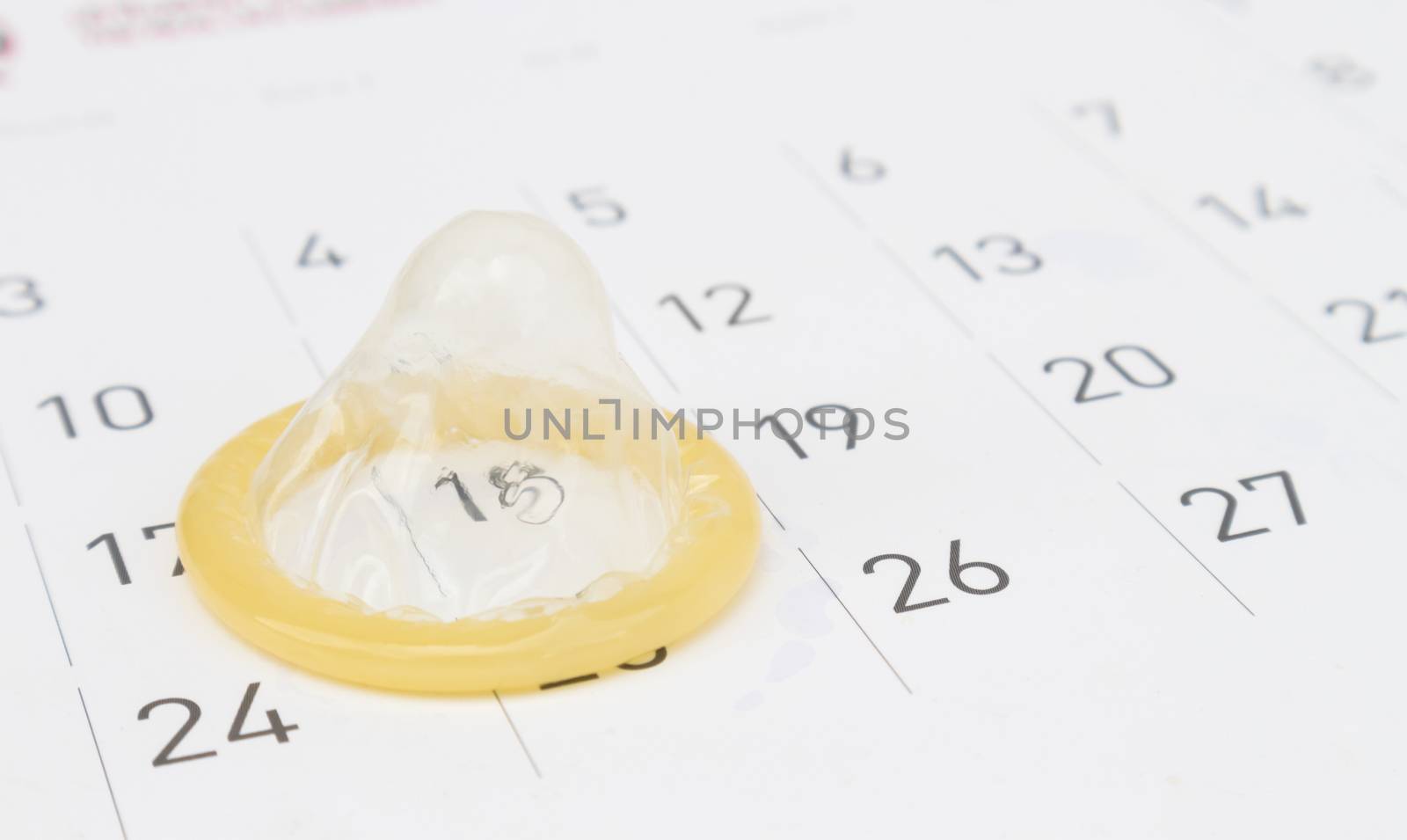 Closeup condom with calendar background for AIDs awareness concept