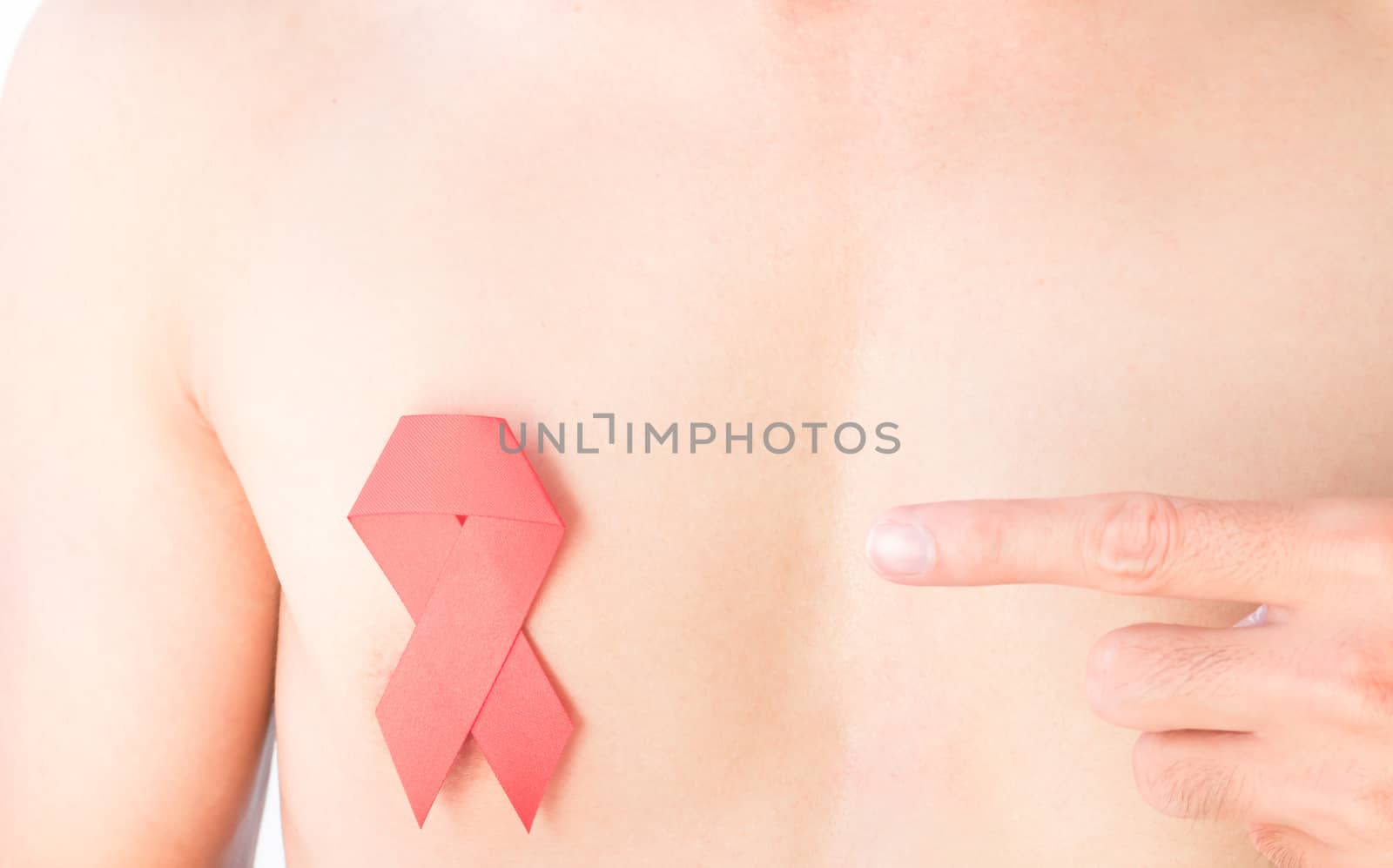 Hand pointer finger to red ribbon on chest for AIDs awareness by pt.pongsak@gmail.com