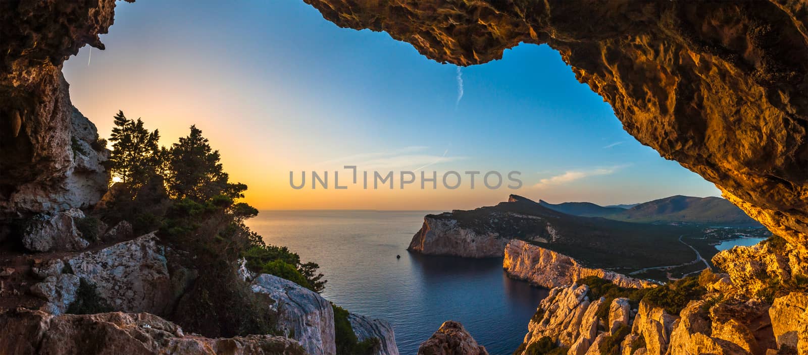 Landscape of the gulf of capo caccia from the Cave of broken vessels at sunset