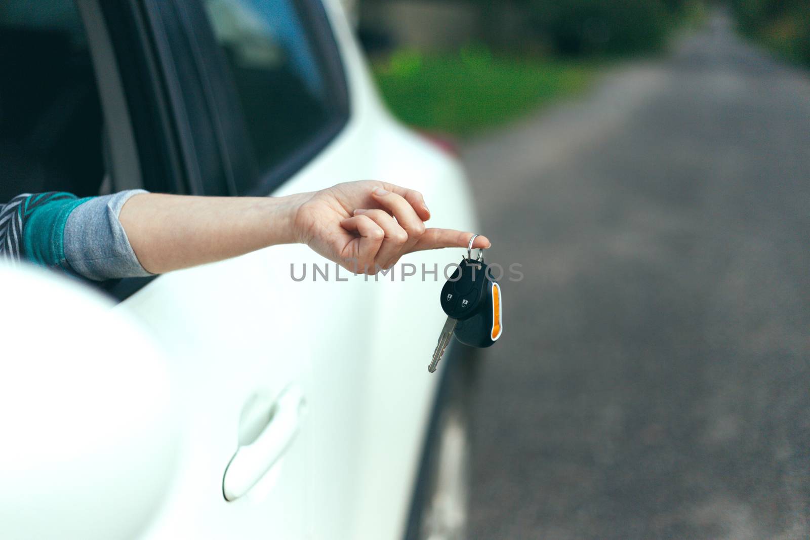 Closeup of car keys hanging on female finger by boys1983@mail.ru