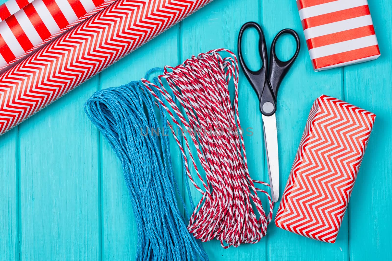 Christmas Gift Wrapping Party Time with Colorful Paper, Ribbon Bows, Scissors a by victosha