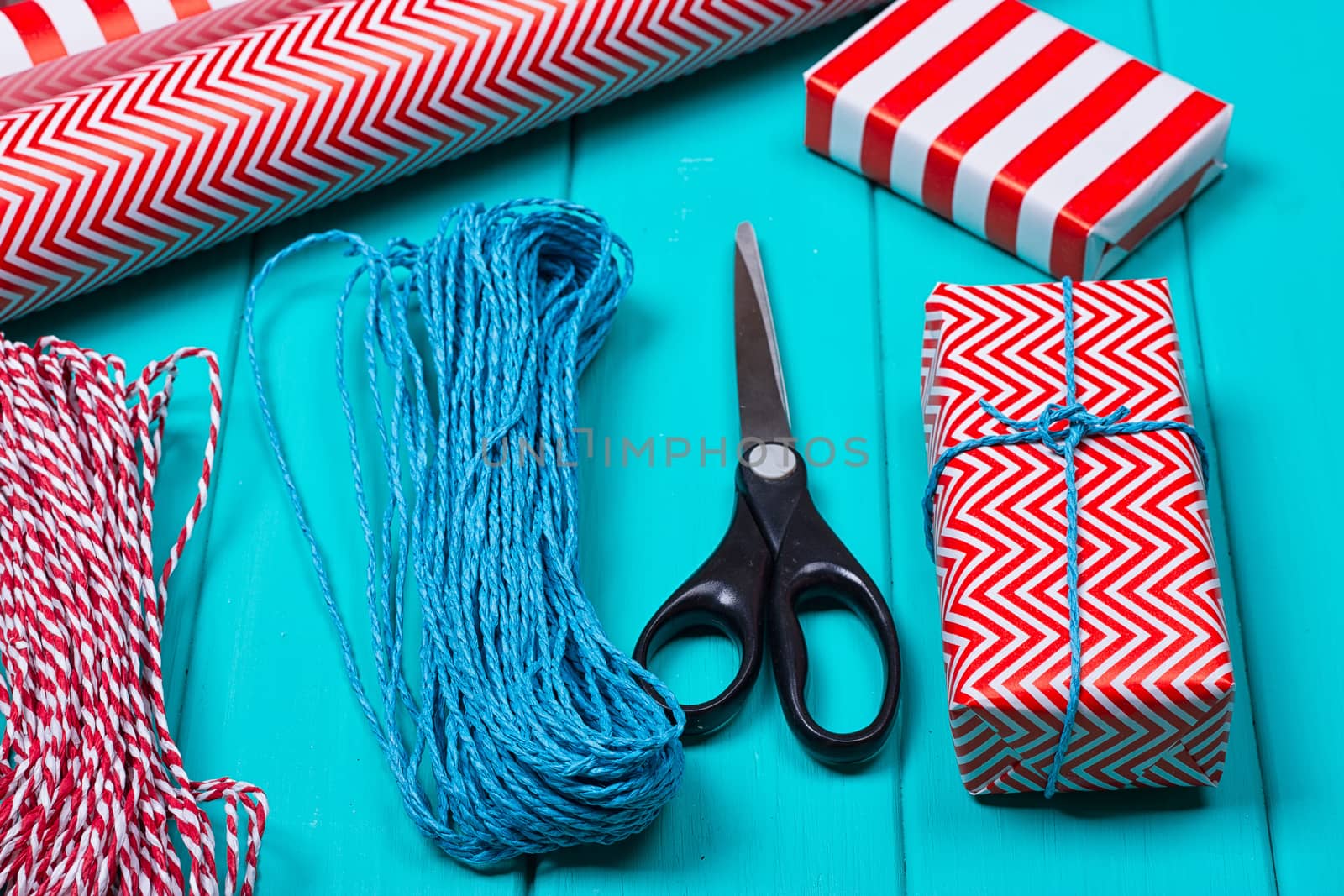 Christmas Gift Wrapping Party Time with Colorful Paper, Ribbon Bows, Scissors a by victosha