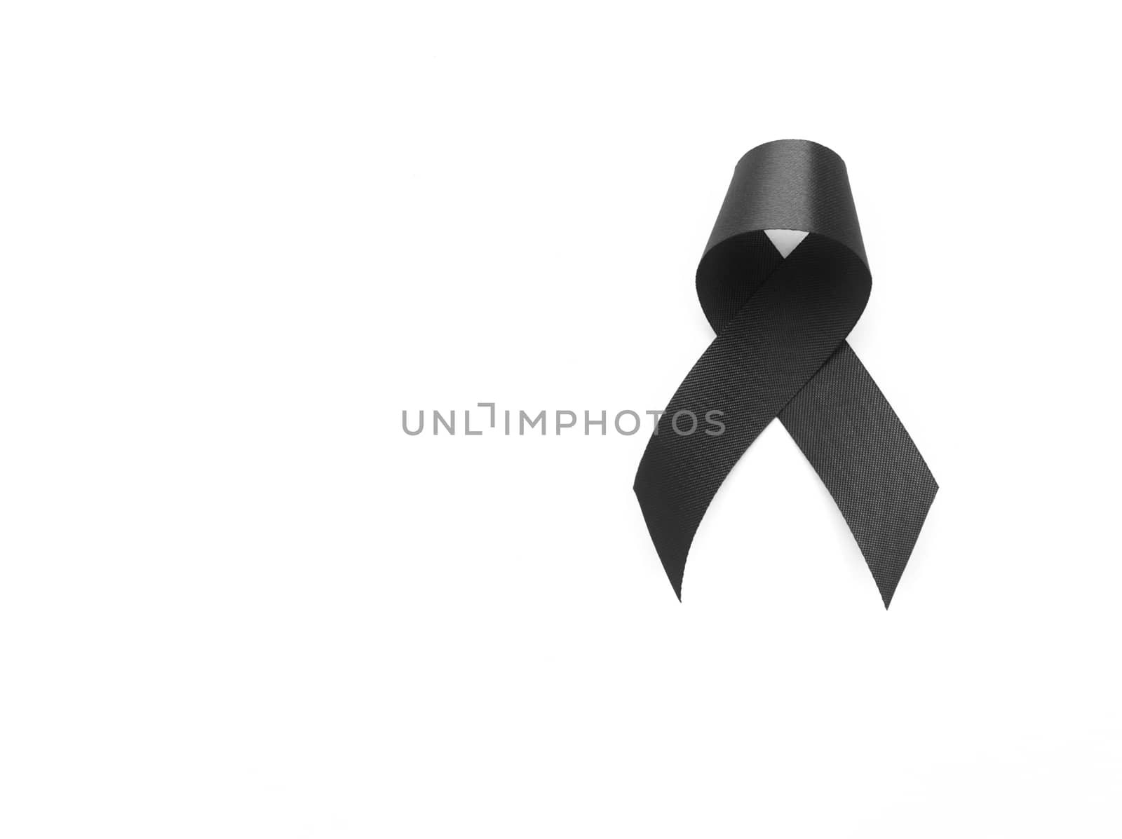 Black ribbon symbol for mourning on white background