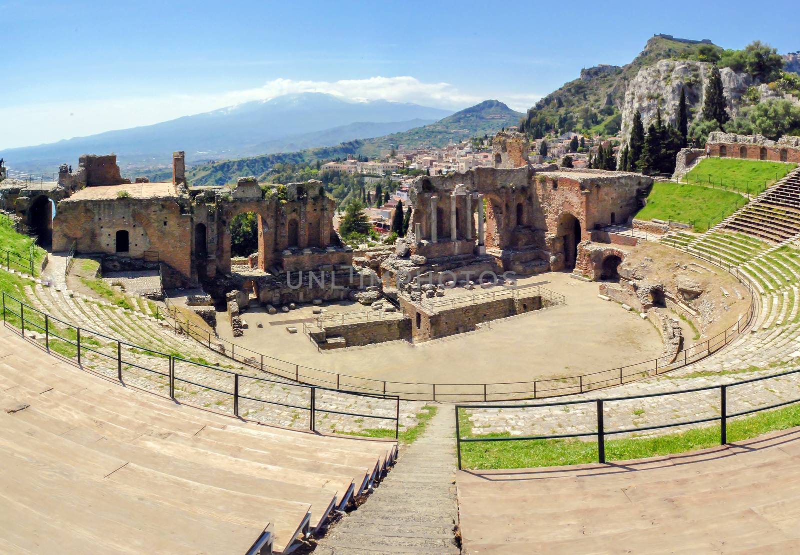 The famous and beautiful ancient greek theatre ruins Taormina with Etna volcano in the distance. outdoor shot, Sicily, Italy