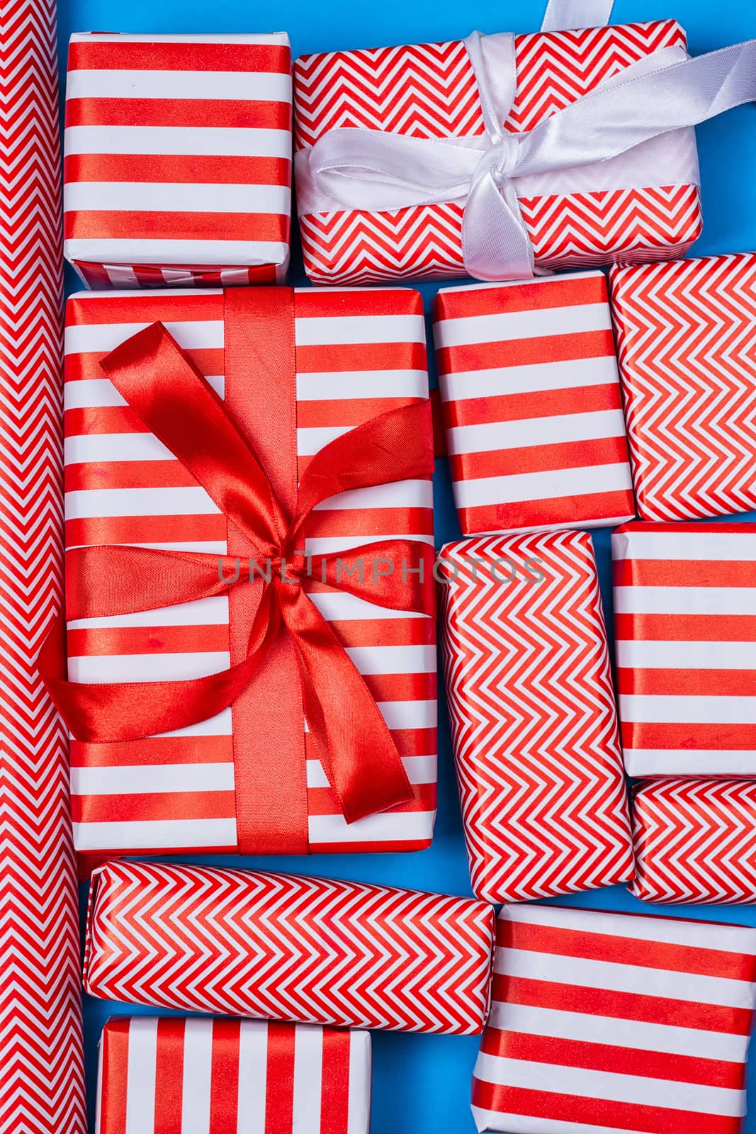 Top view of red and white gifts on the blue background