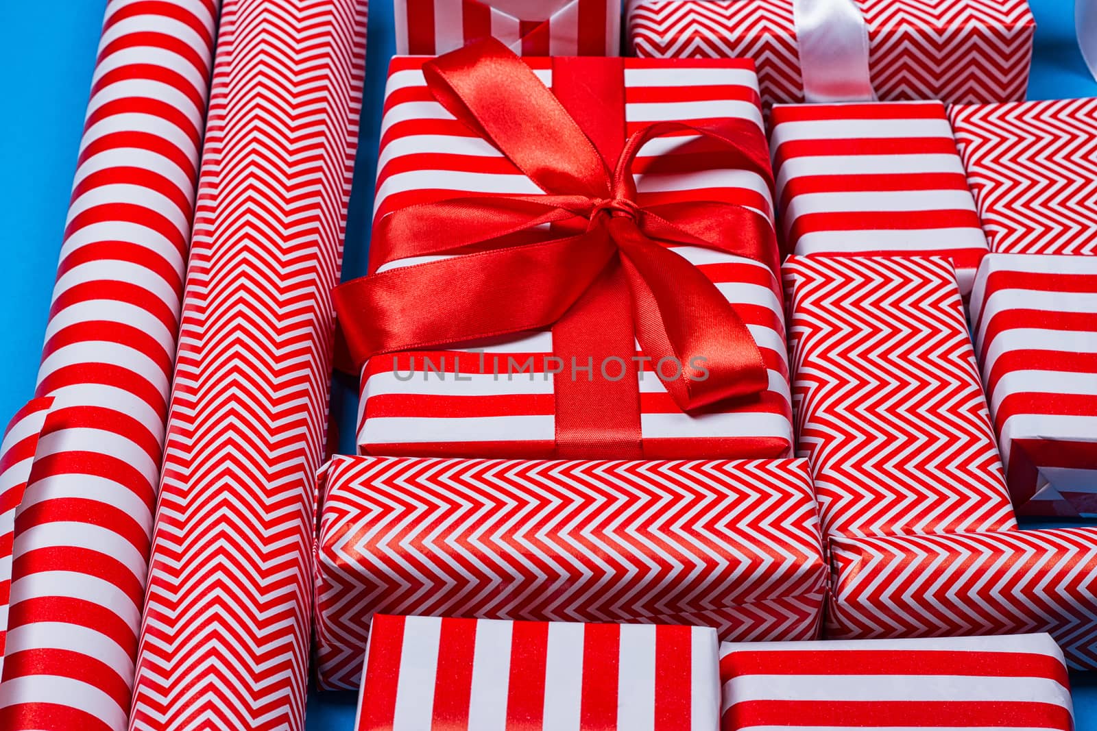 Top view of red and white gifts on the blue background