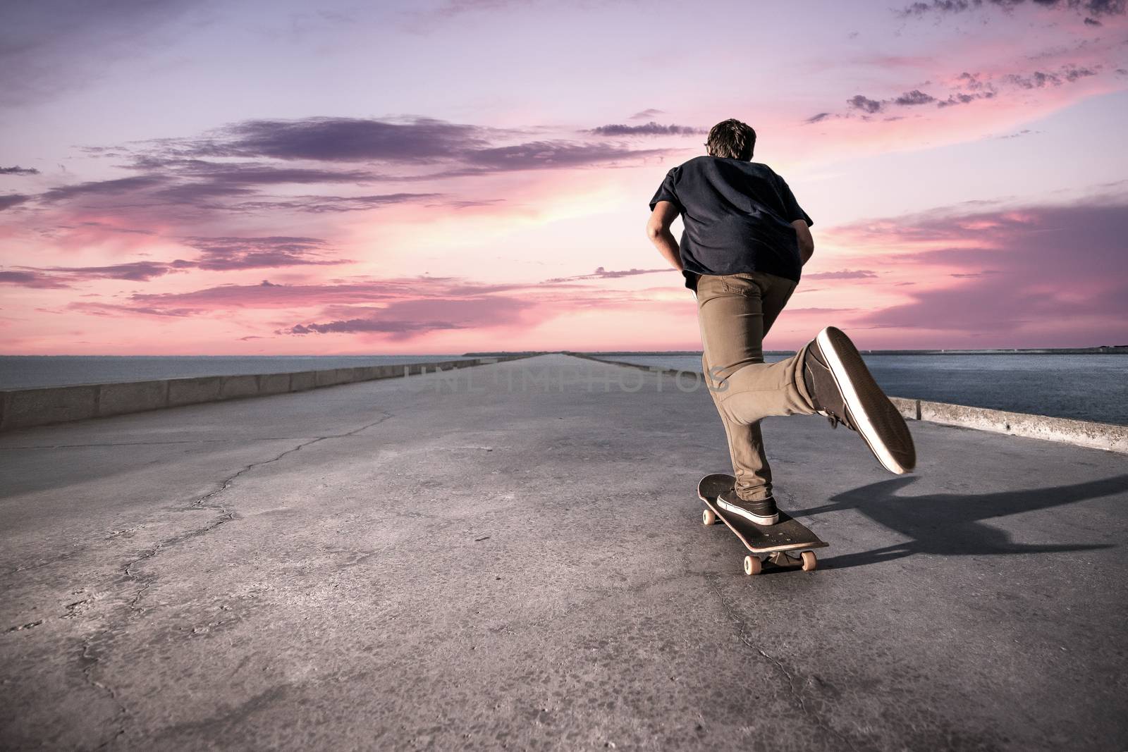 Skateboarder pushing on a concrete pavement by homydesign