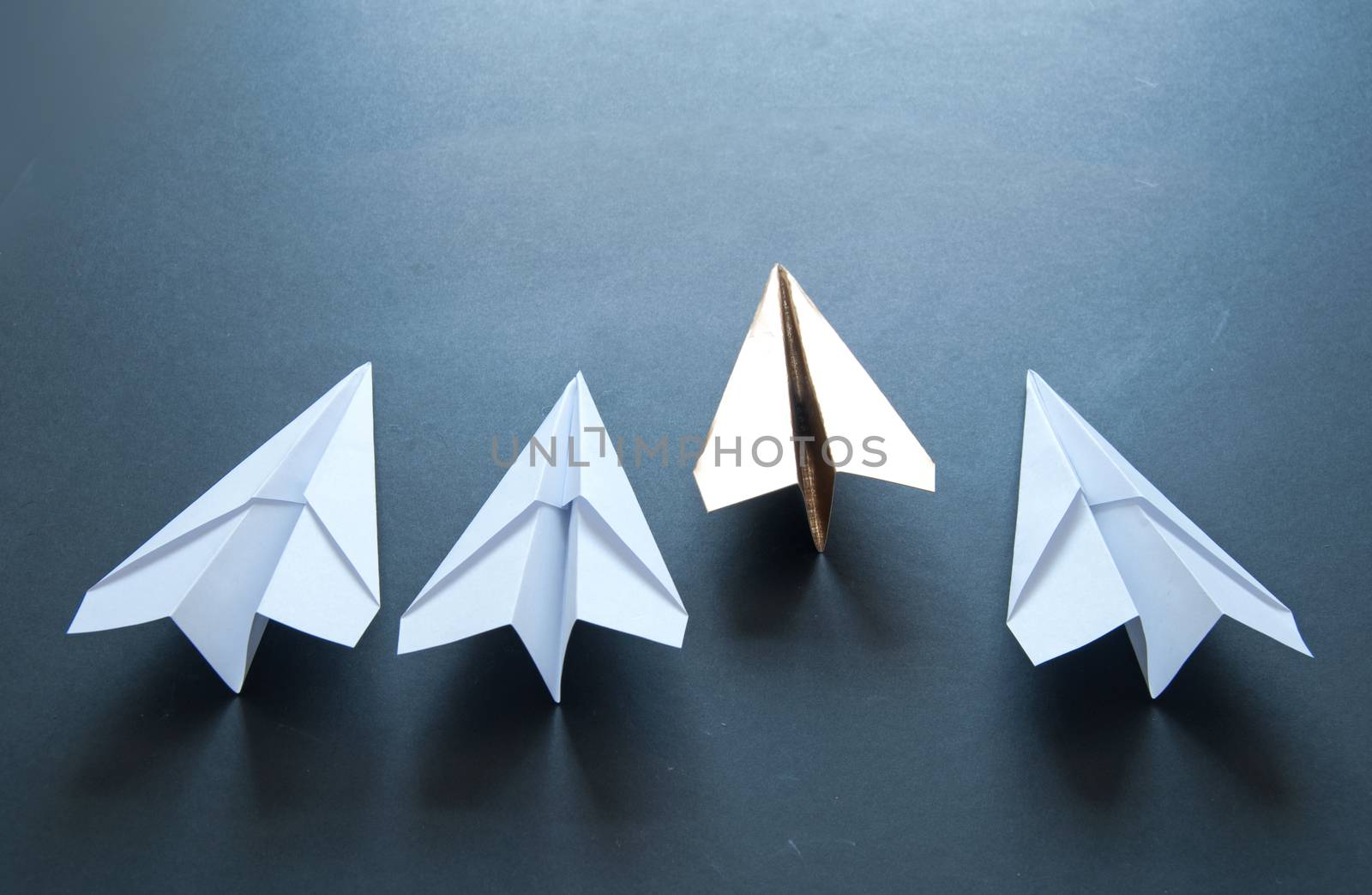 Gold paper plane leader concept by unikpix