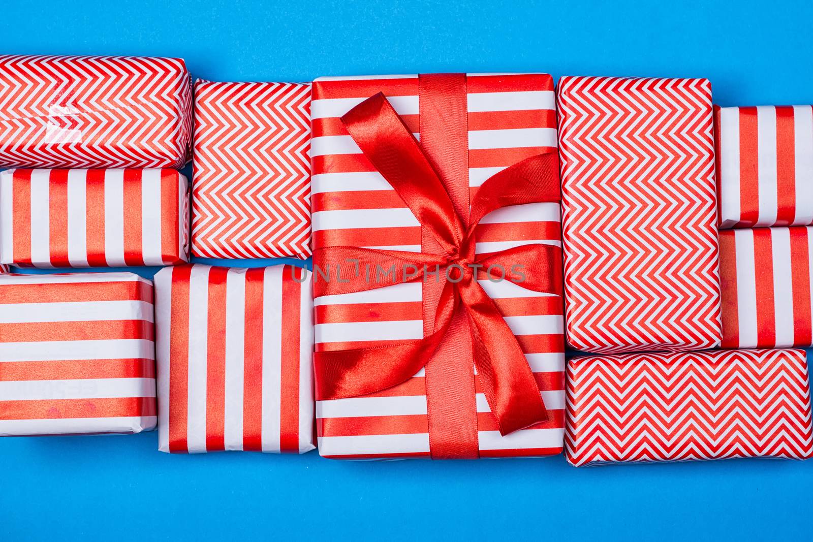 Top view of red and white gifts on the blue background