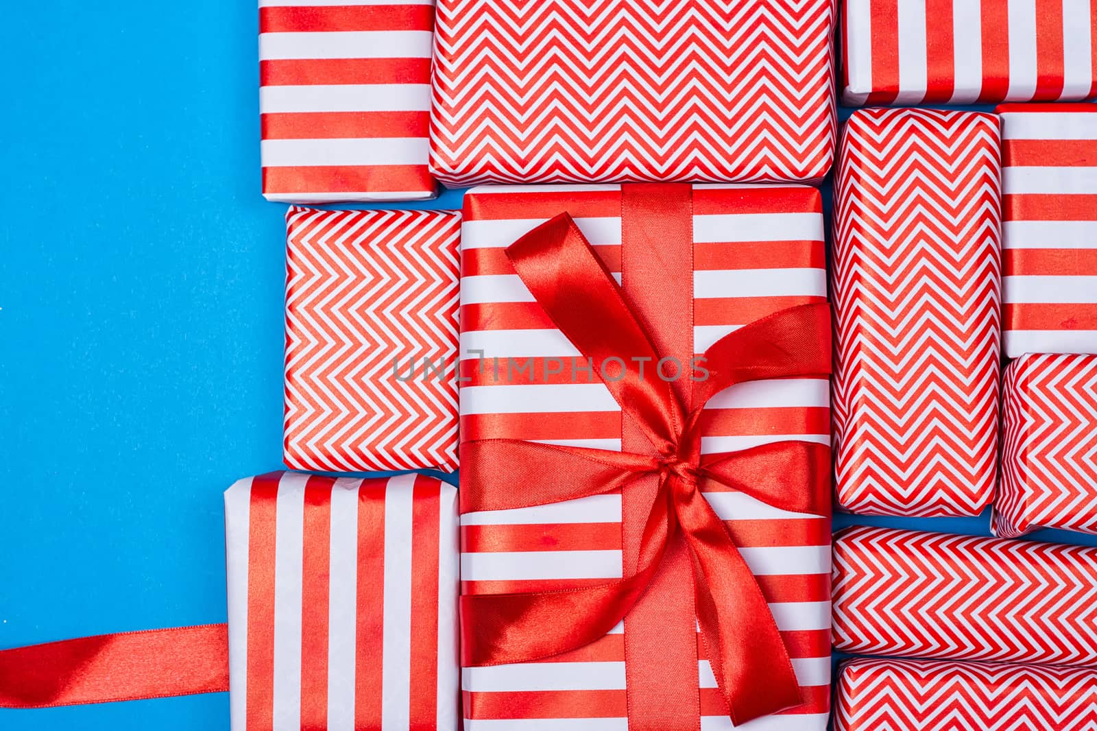 Top view of red and white gifts on the blue background