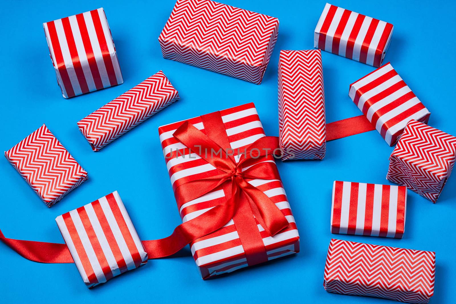 Top view of red and white gifts on the blue background