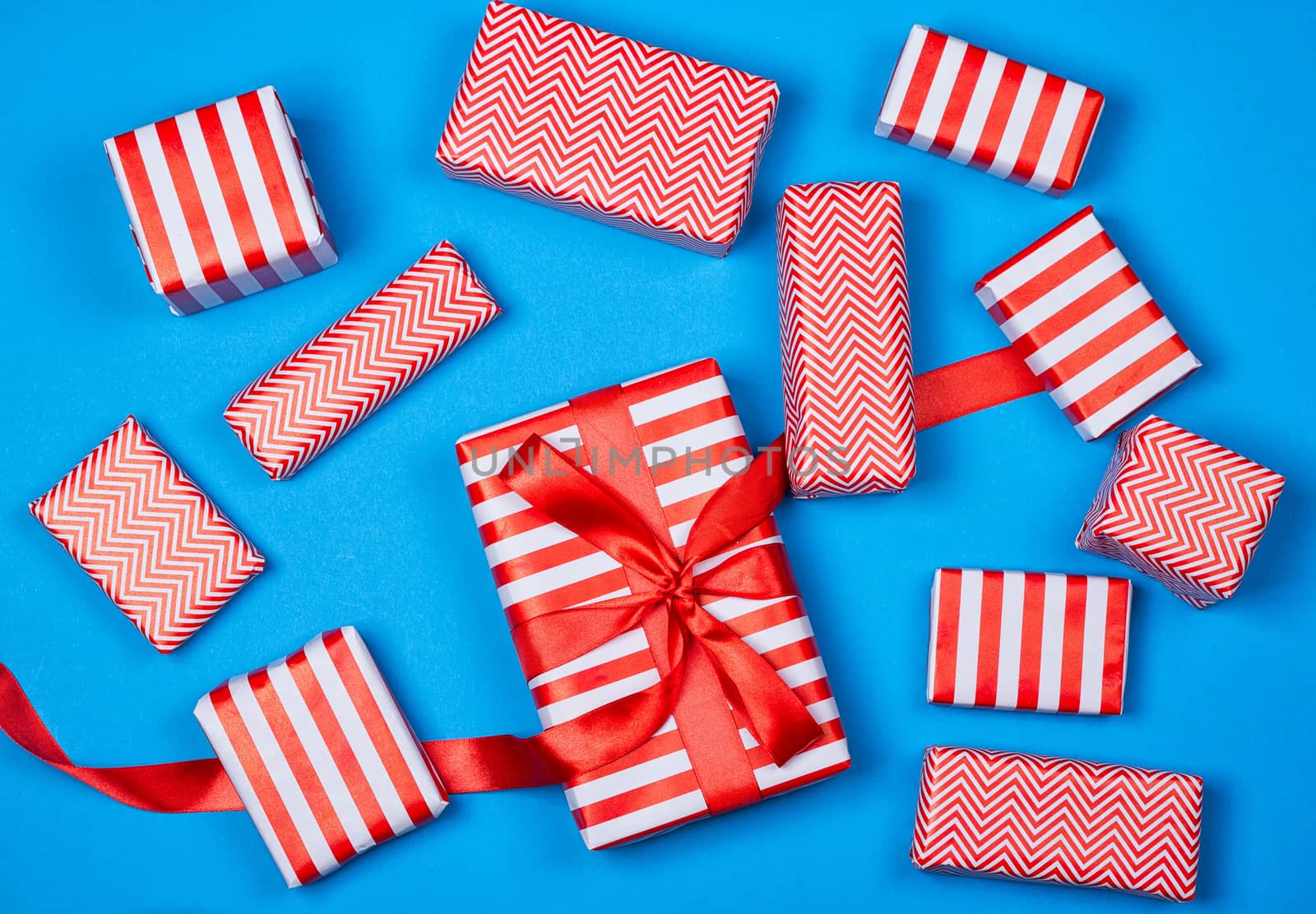 Top view of red and white gifts on the blue background