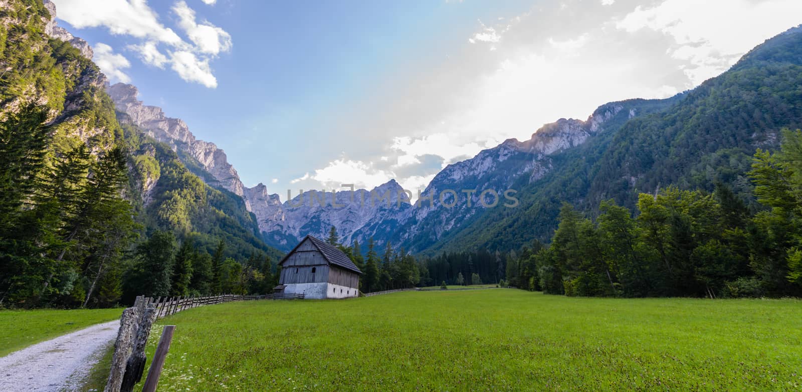 Mountain farm house on meadow in European Alps, located in Robanov kot, Slovenia, popular hiking and climbing place with picturescue view