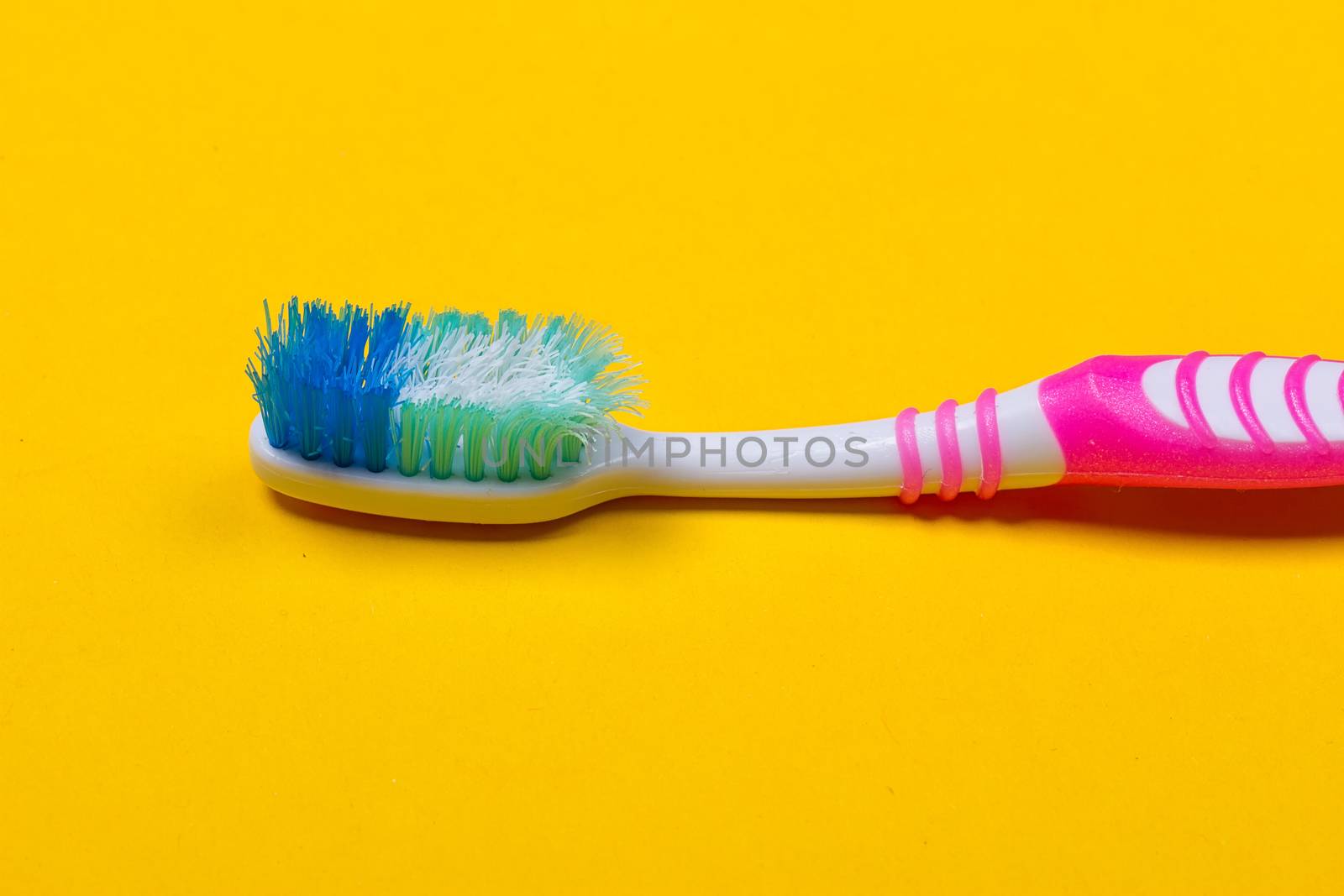 Toothbrushes on yellow background by victosha