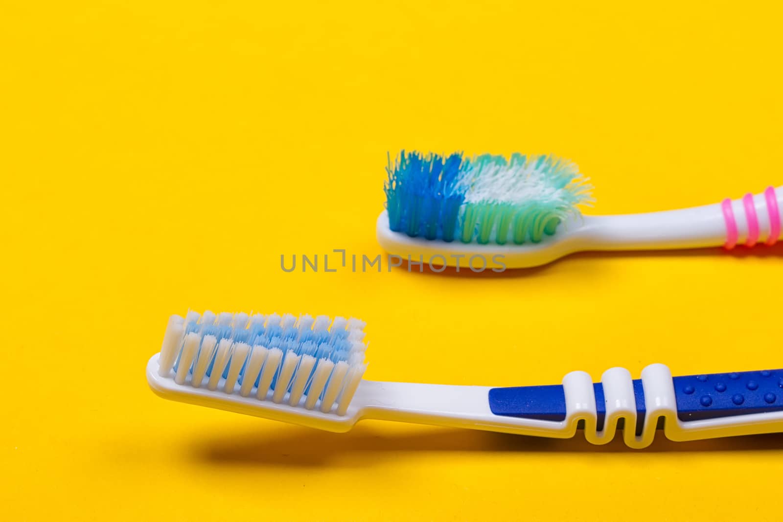 Toothbrushes on yellow background by victosha