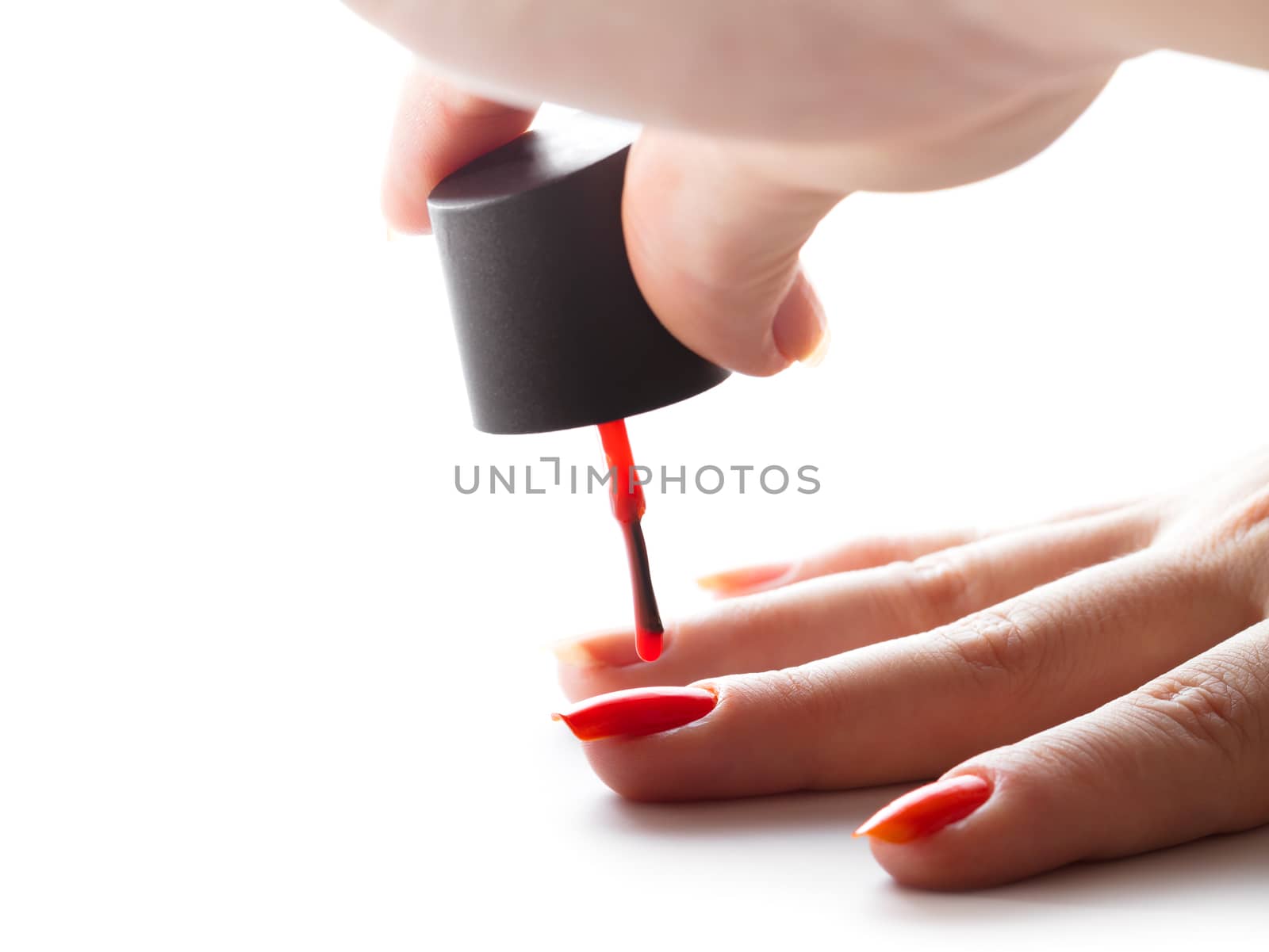 hand care, nail painting with red lacquer