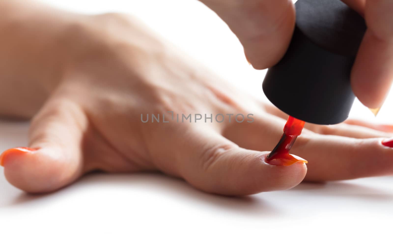 hand care, nail painting with red lacquer