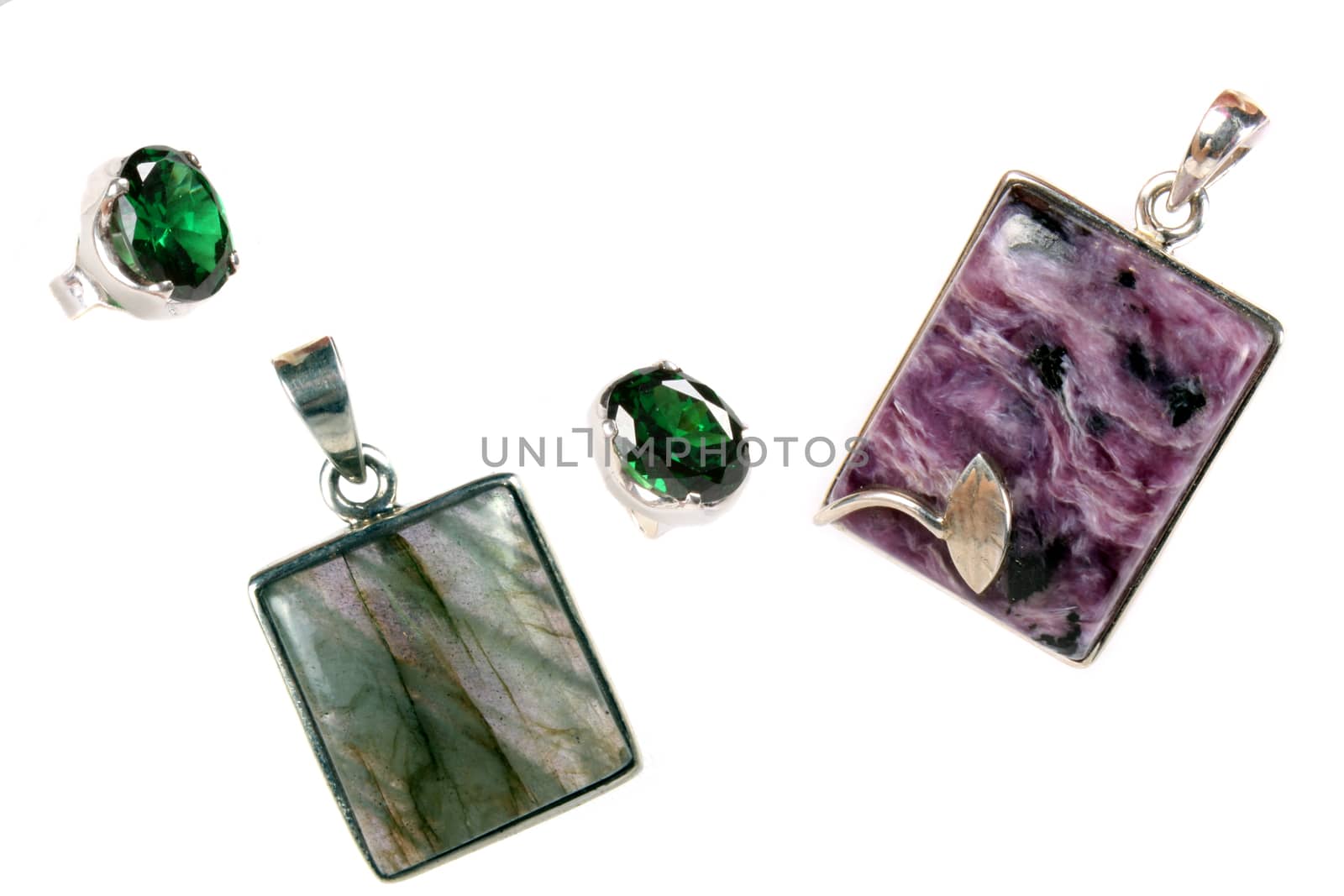 A set of pendants and rings made of silver and semi-precious stones of different colors.