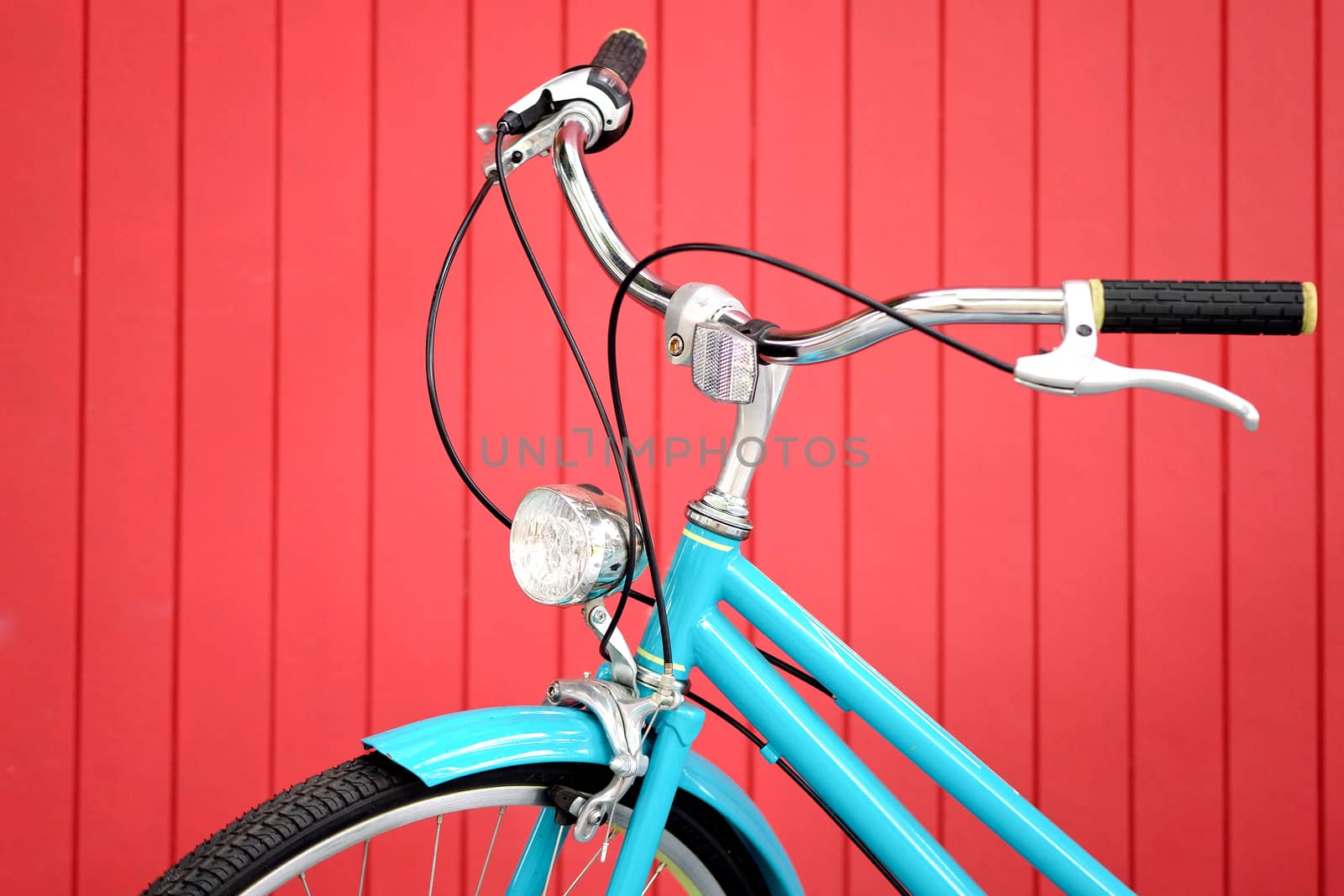 retro bicycle in front of the red wall background