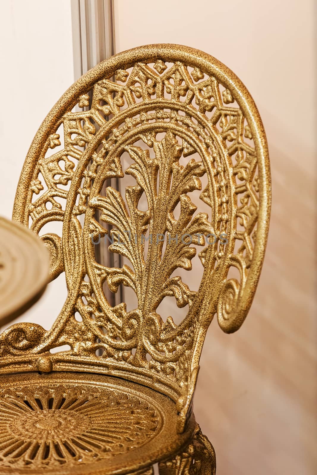 chair made of wrought iron with gold color, note shallow depth of field