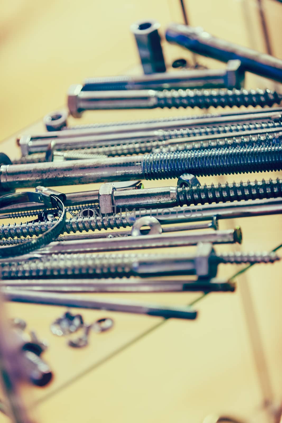 screws, nuts, clamps ...on the glass, note shallow depth of field