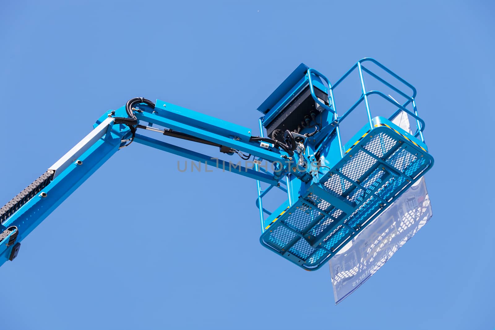 Crane with basket on the blue background, note shallow depth of field