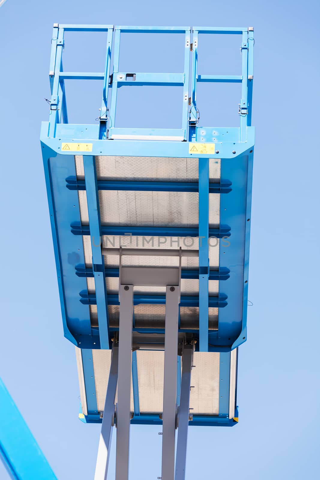 Crane with basket on the blue background, note shallow depth of field