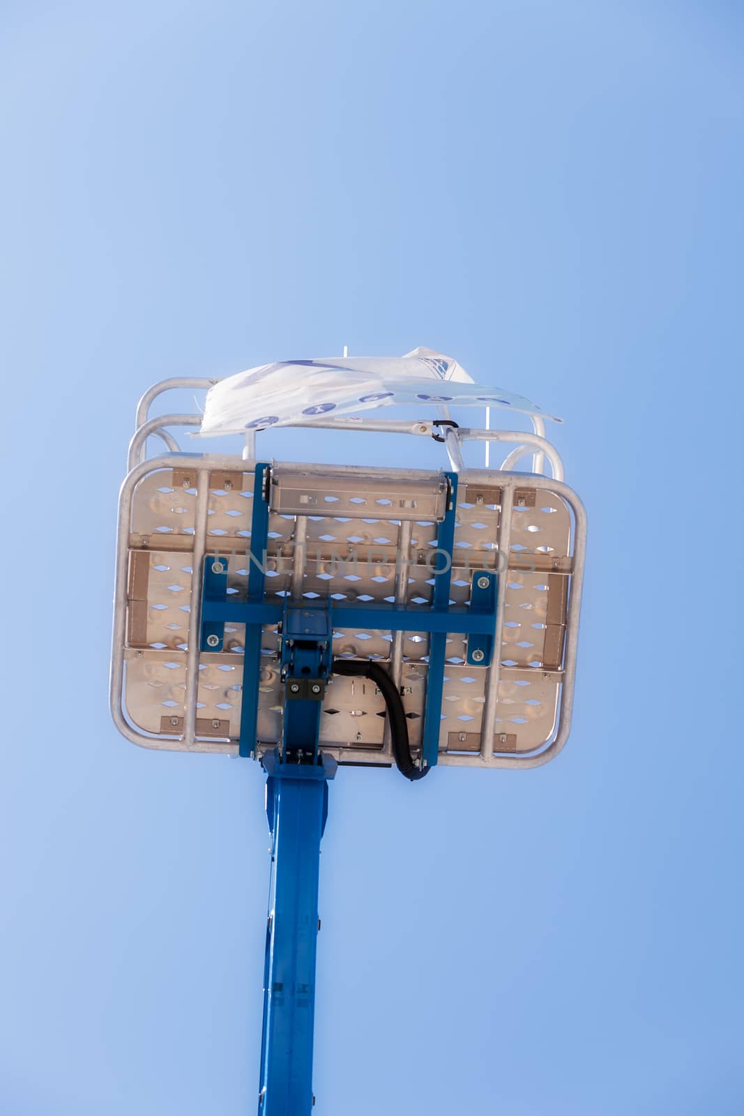 Crane with basket on the blue background, note shallow depth of field