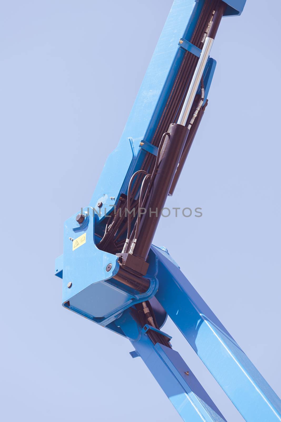 Details crane in construction on the blue background, note shallow depth of field