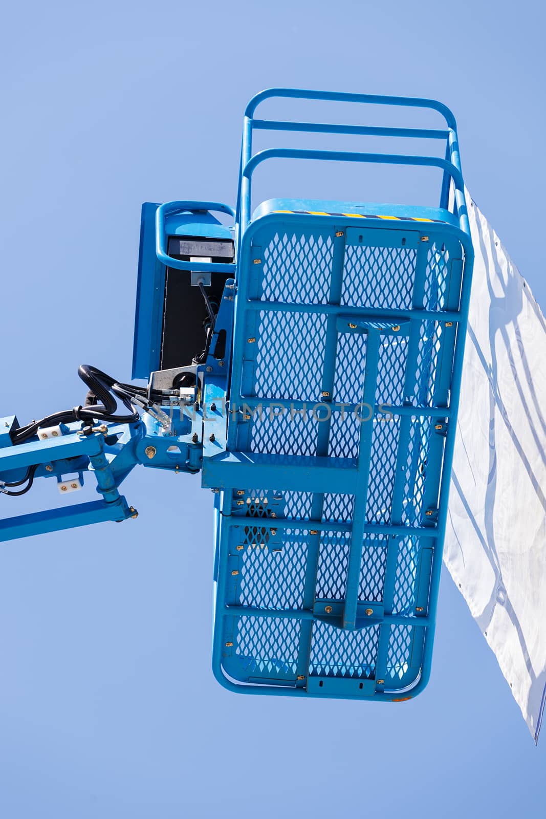 Crane with basket on the blue background, note shallow depth of field